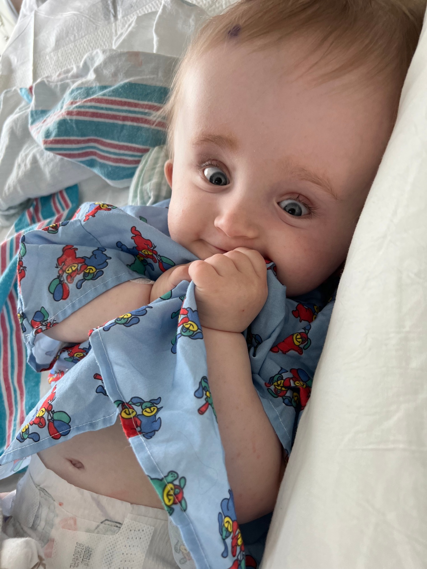 Harlow smiling in the hospital with her blanket