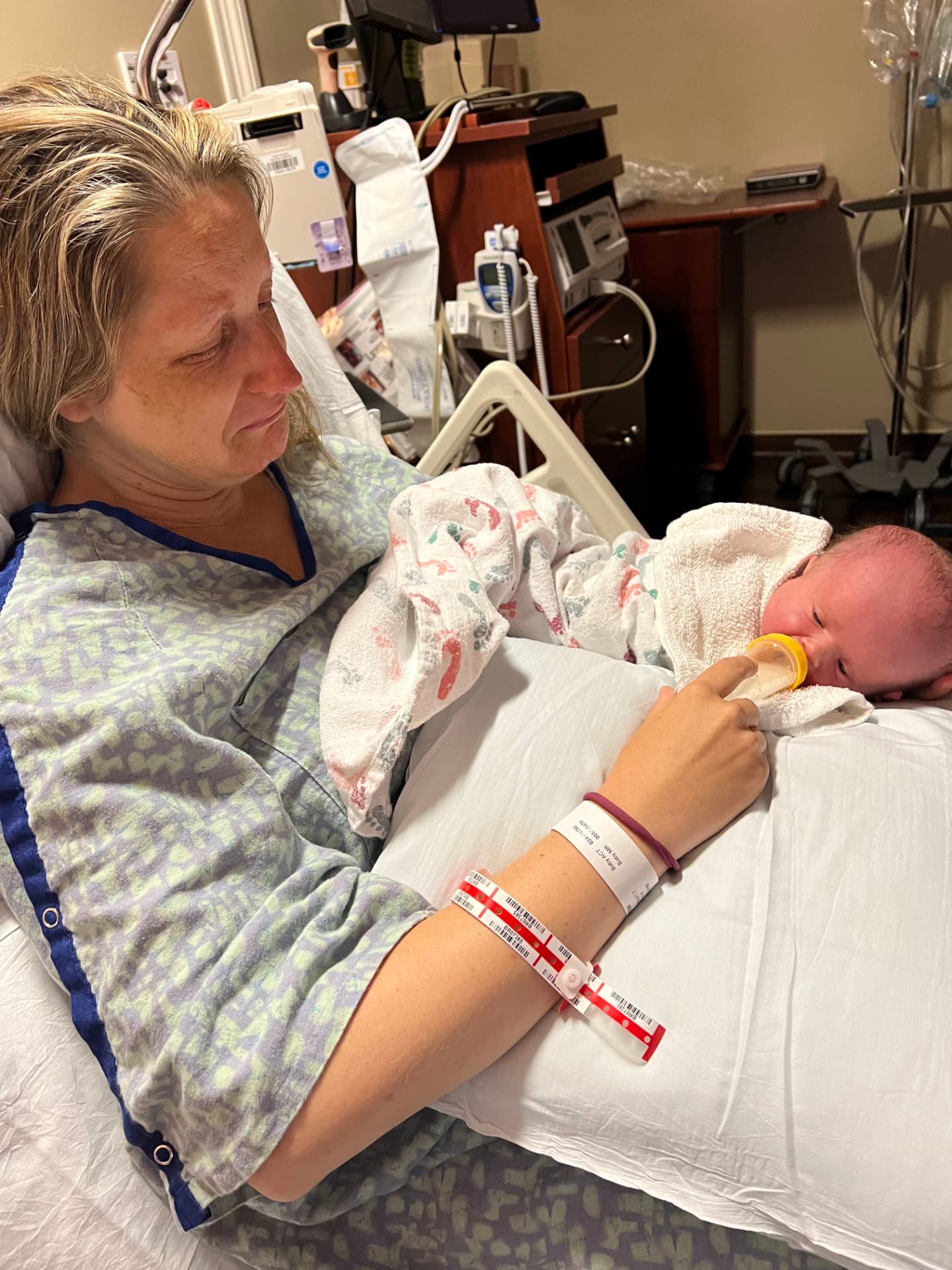 Kristen feeding newborn Harlow in the hospital