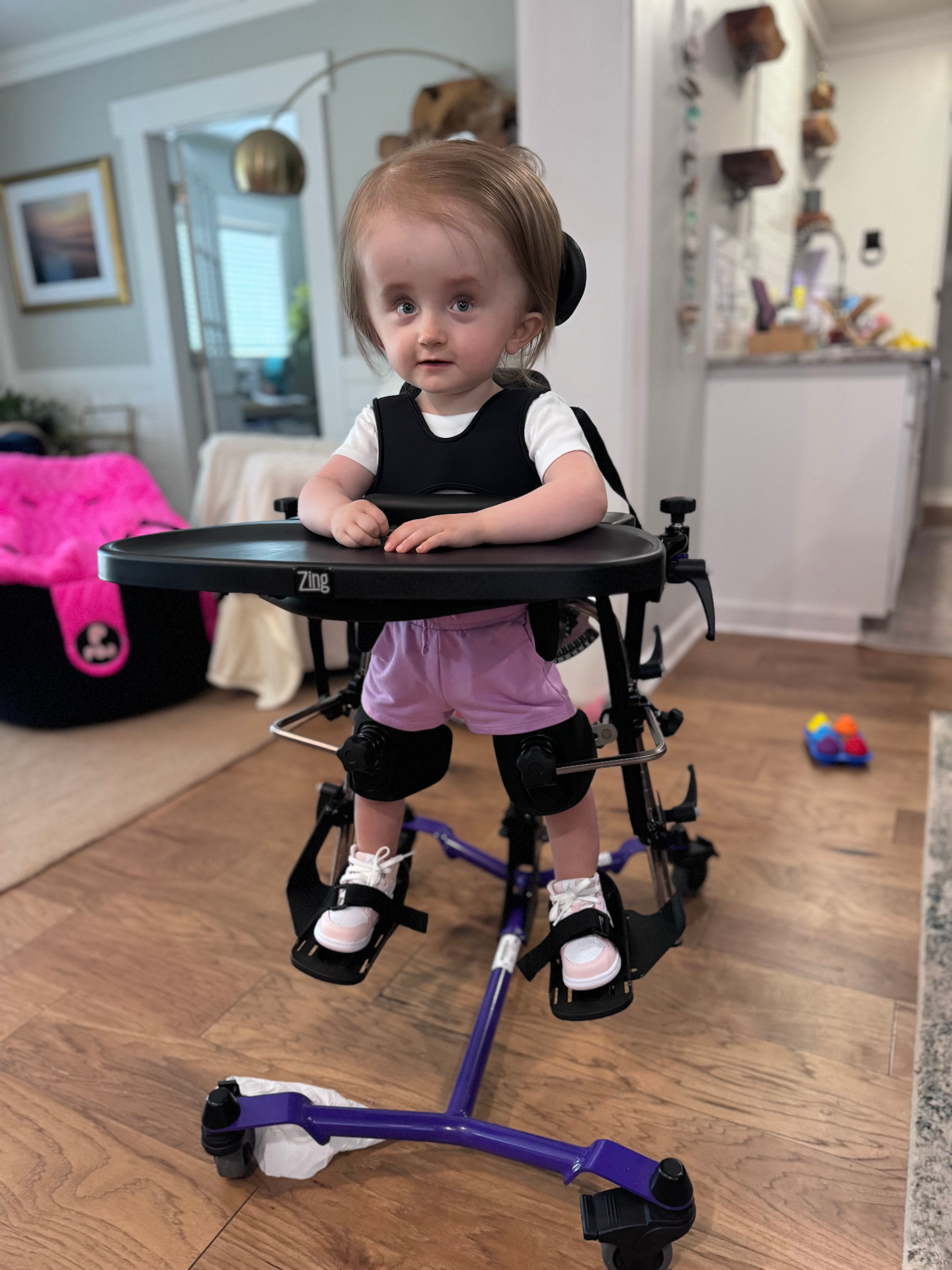 Harlow in her purple stander with a tray